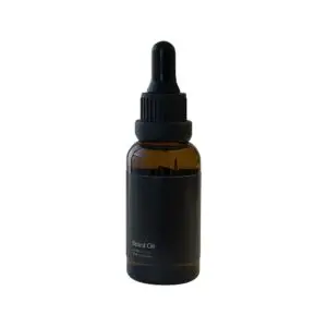 On a white background, an image of a bottle of beard oil, an essential product for maintaining and nourishing facial hair.